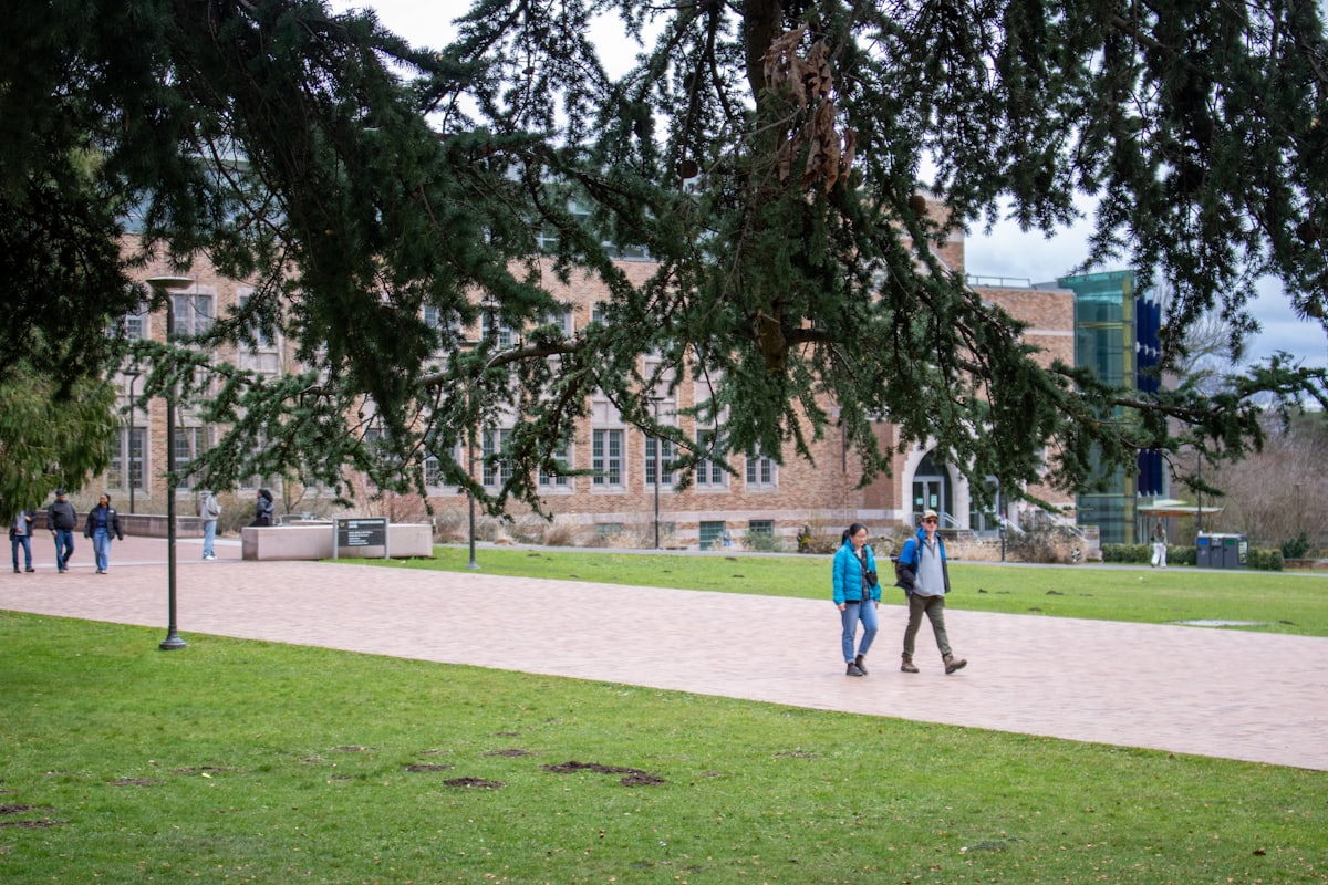 Students walking across a college campus between classes